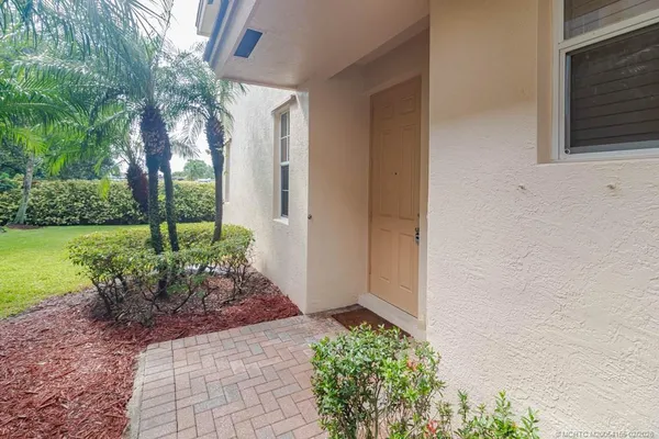 a view of a house with a yard and plants