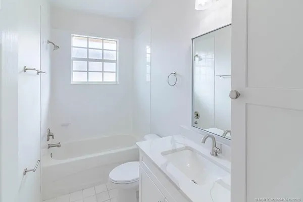 an aerial view of a house with a yard and lake view