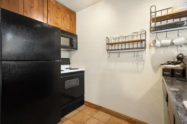 a kitchen with a refrigerator and a stove