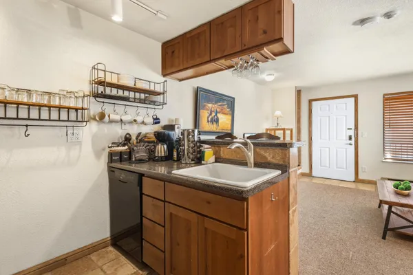 a kitchen with sink refrigerator and cabinets