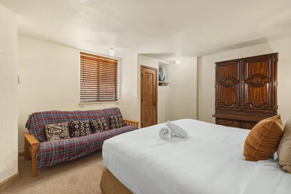 a bedroom with a bed and window