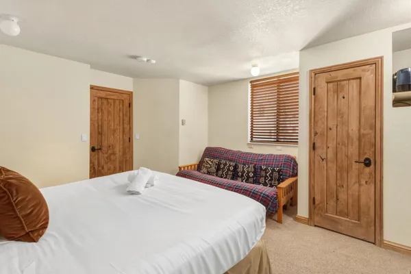 a bedroom with a large bed and a window