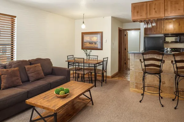 a living room with furniture a lamp and a dining table
