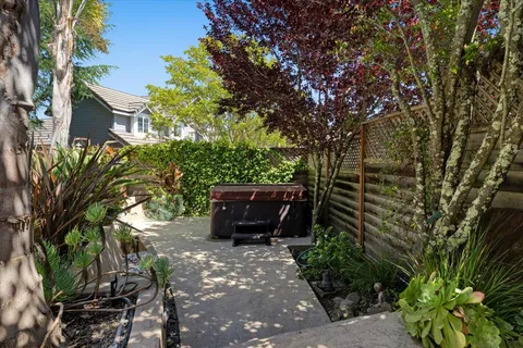 a view of a backyard with table and chairs and wooden fence