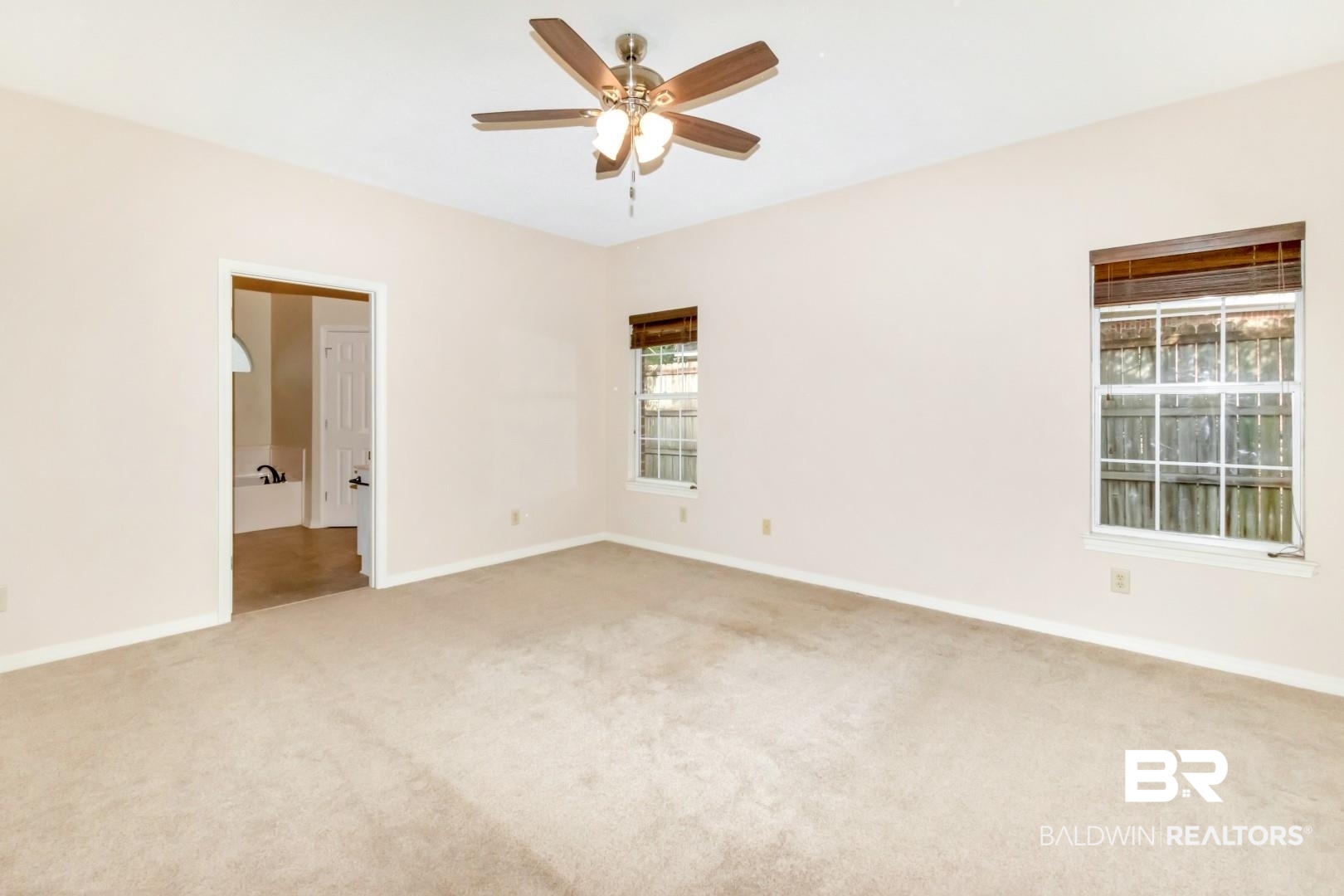 152 Ideal Avenue Mobile, AL 36608 - Photo 21 of 32 Carpeted empty room featuring ceiling fan and a healthy amount of sunlight