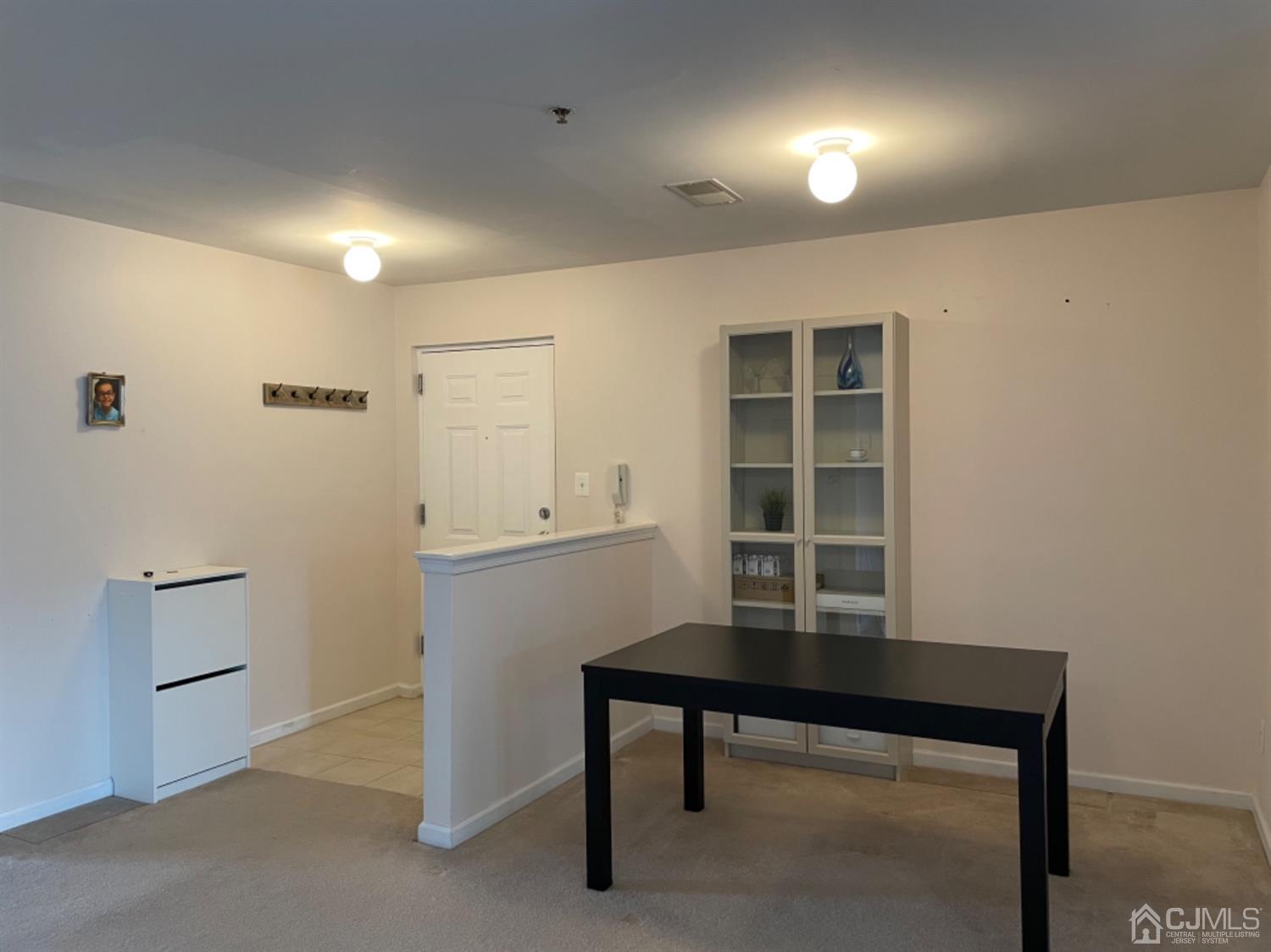 1124 Edpas Road New Brunswick, NJ 08901 - Photo 4 of 24 a room that has a table and a chair