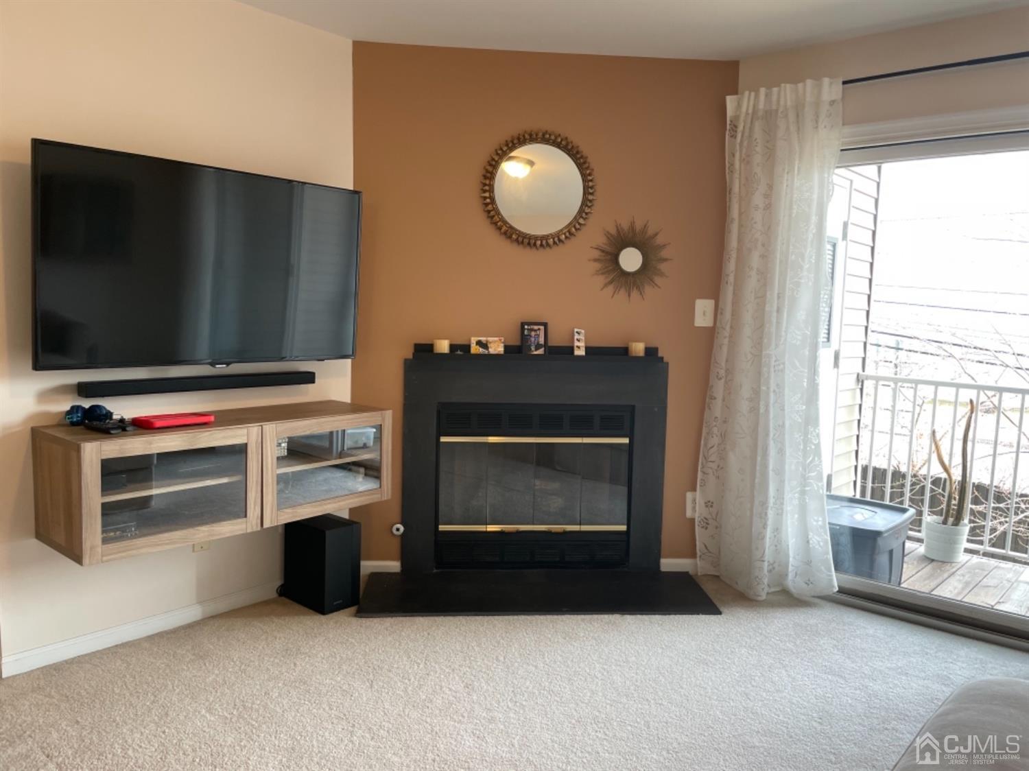 1124 Edpas Road New Brunswick, NJ 08901 - Photo 5 of 24 a living room with furniture a flat screen tv and a fireplace
