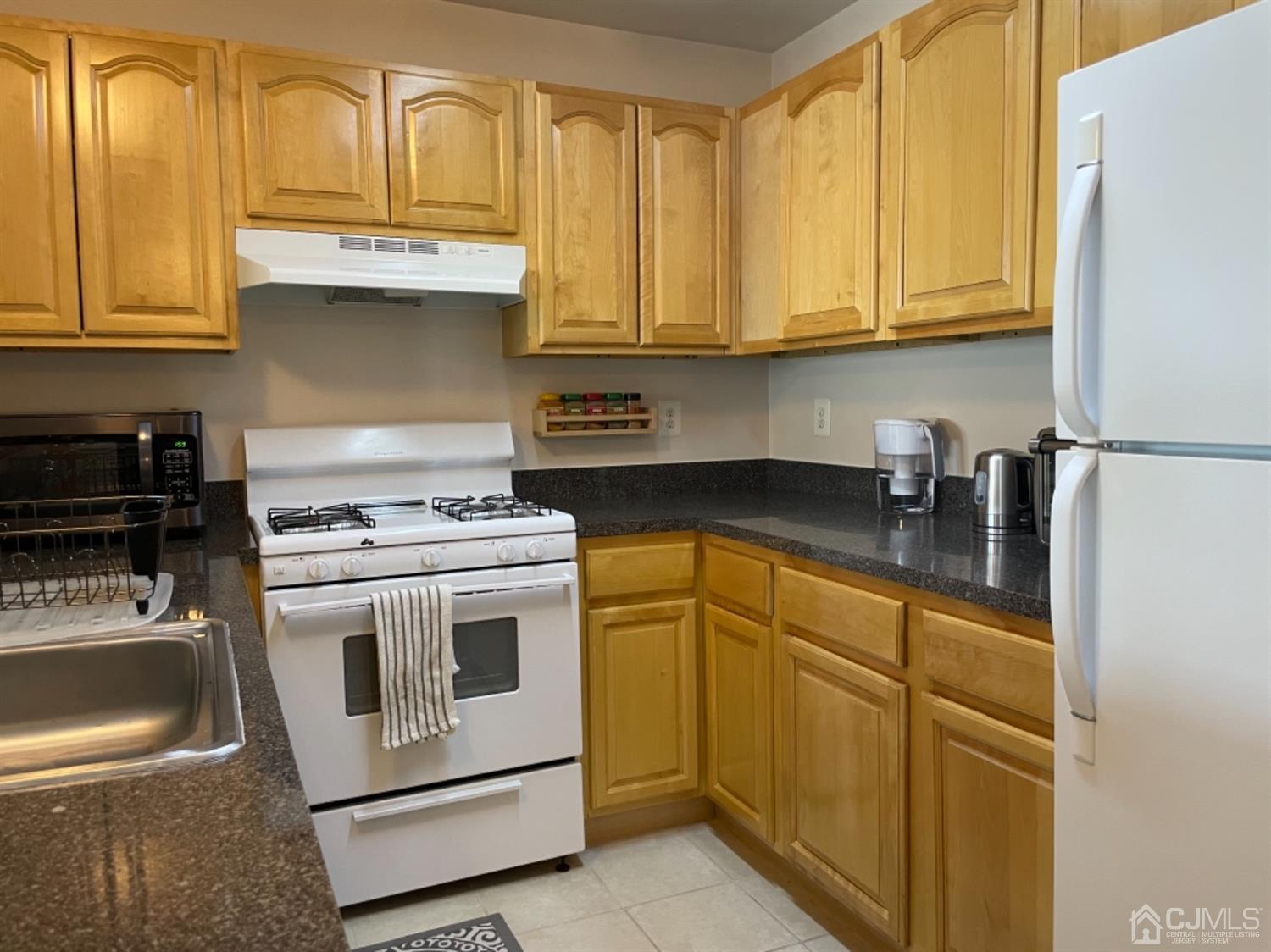 1124 Edpas Road New Brunswick, NJ 08901 - Photo 9 of 24 a kitchen with stainless steel appliances granite countertop a stove and a refrigerator