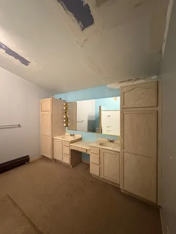 a view of bathroom with shower and wooden floor