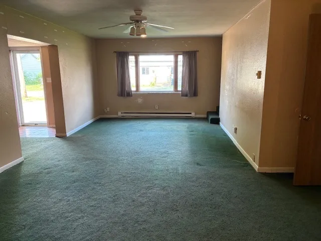 an empty room with windows and entrance