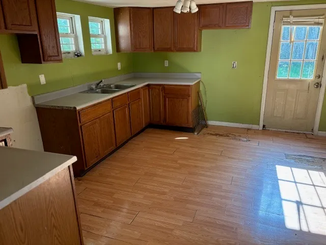 a kitchen with a sink and wooden cabinets