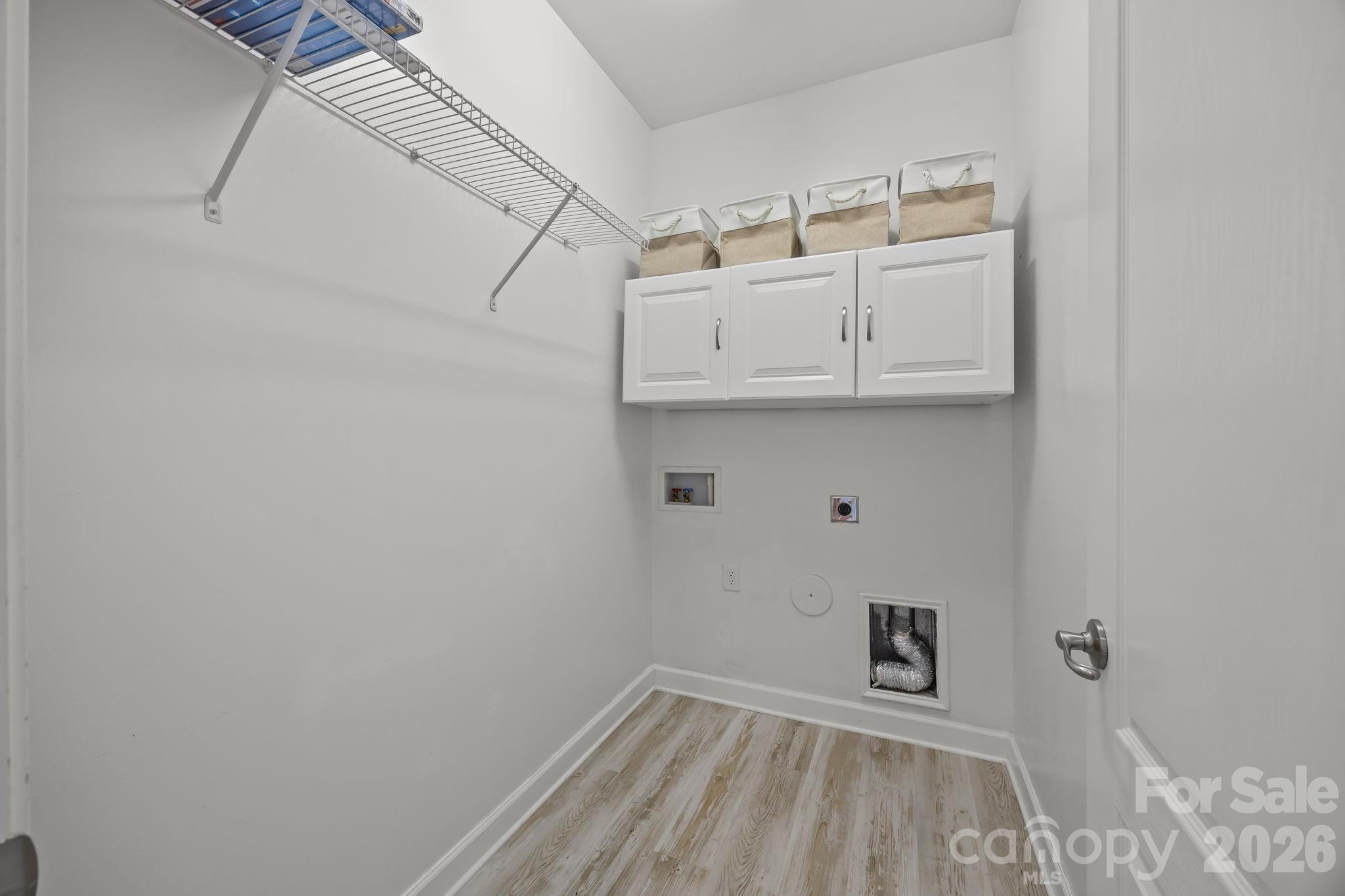 11422 Potters Row Cornelius, NC 28031 - Photo 11 of 46 a view of storage and utility room with wooden floor
