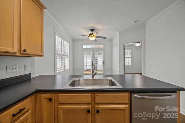 an empty room with wooden floor closet and windows
