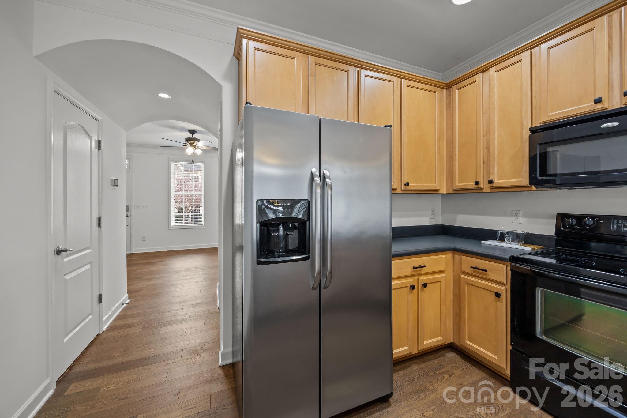 11422 Potters Row Cornelius, NC 28031 - Photo 13 of 46 a kitchen with stainless steel appliances granite countertop a refrigerator a sink and white cabinets