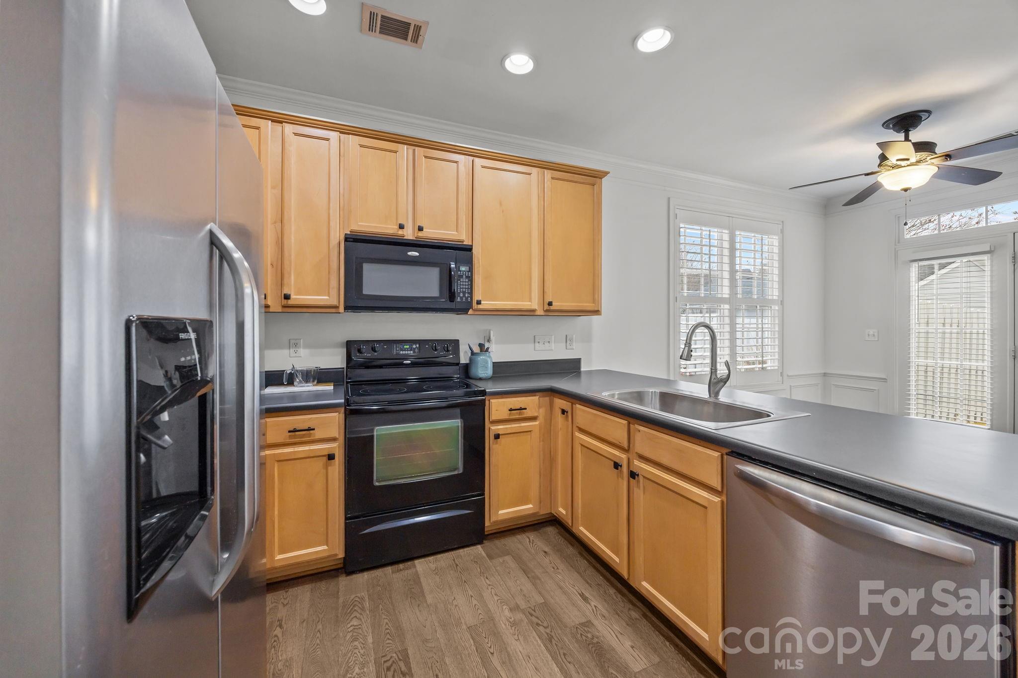 11422 Potters Row Cornelius, NC 28031 - Photo 14 of 46 a kitchen with stainless steel appliances granite countertop a stove a sink and a refrigerator