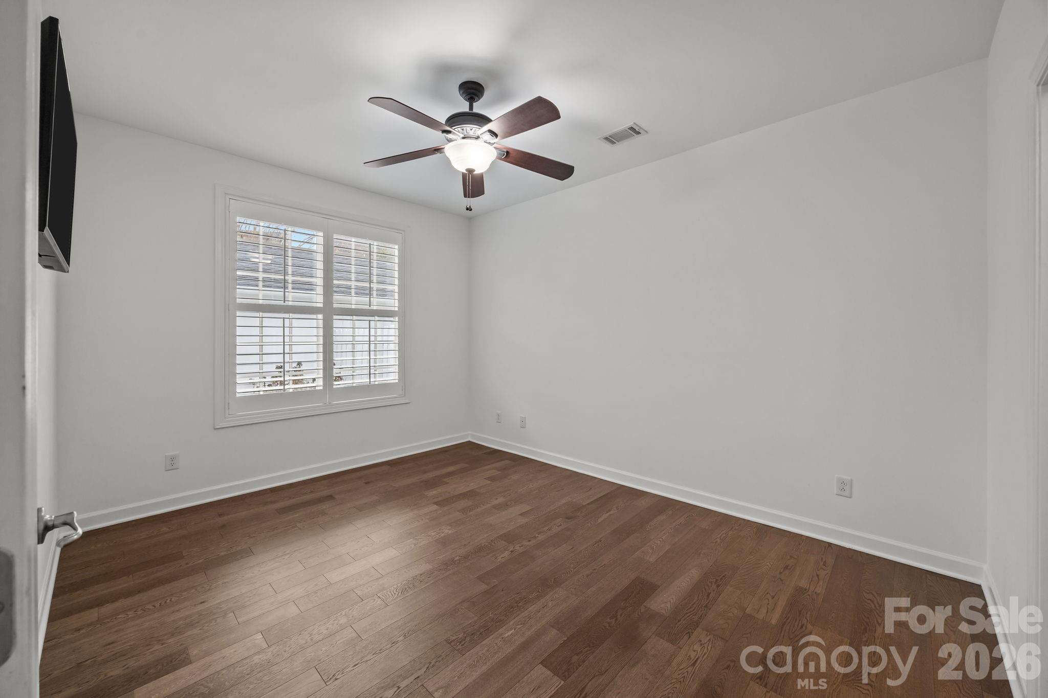 11422 Potters Row Cornelius, NC 28031 - Photo 19 of 46 an empty room with wooden floor closet and windows