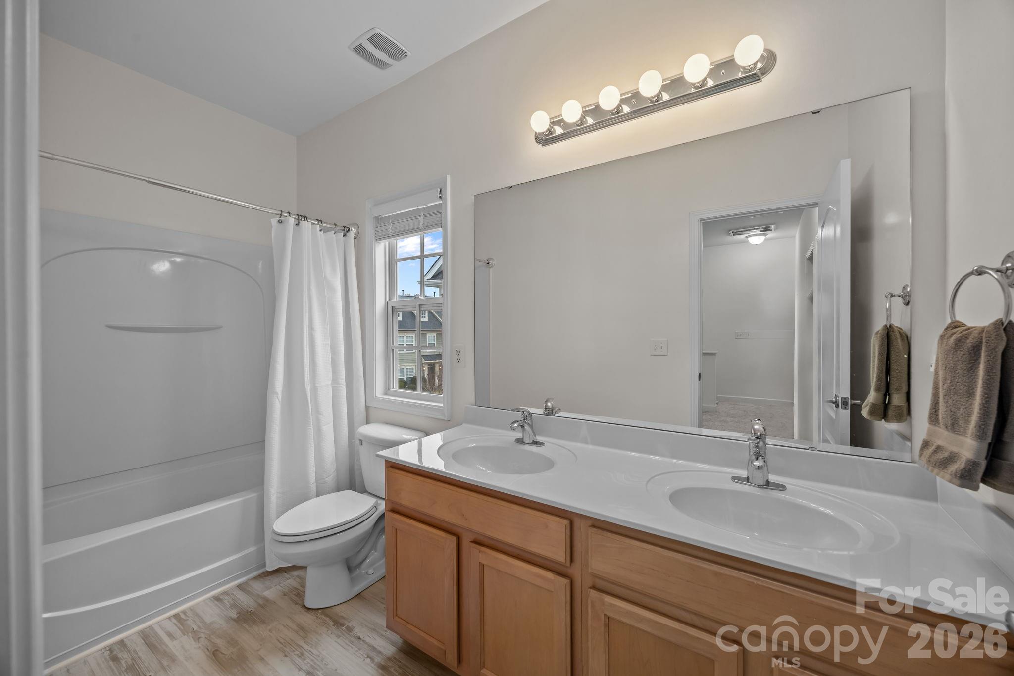 11422 Potters Row Cornelius, NC 28031 - Photo 26 of 46 a bathroom with a sink a toilet and shower