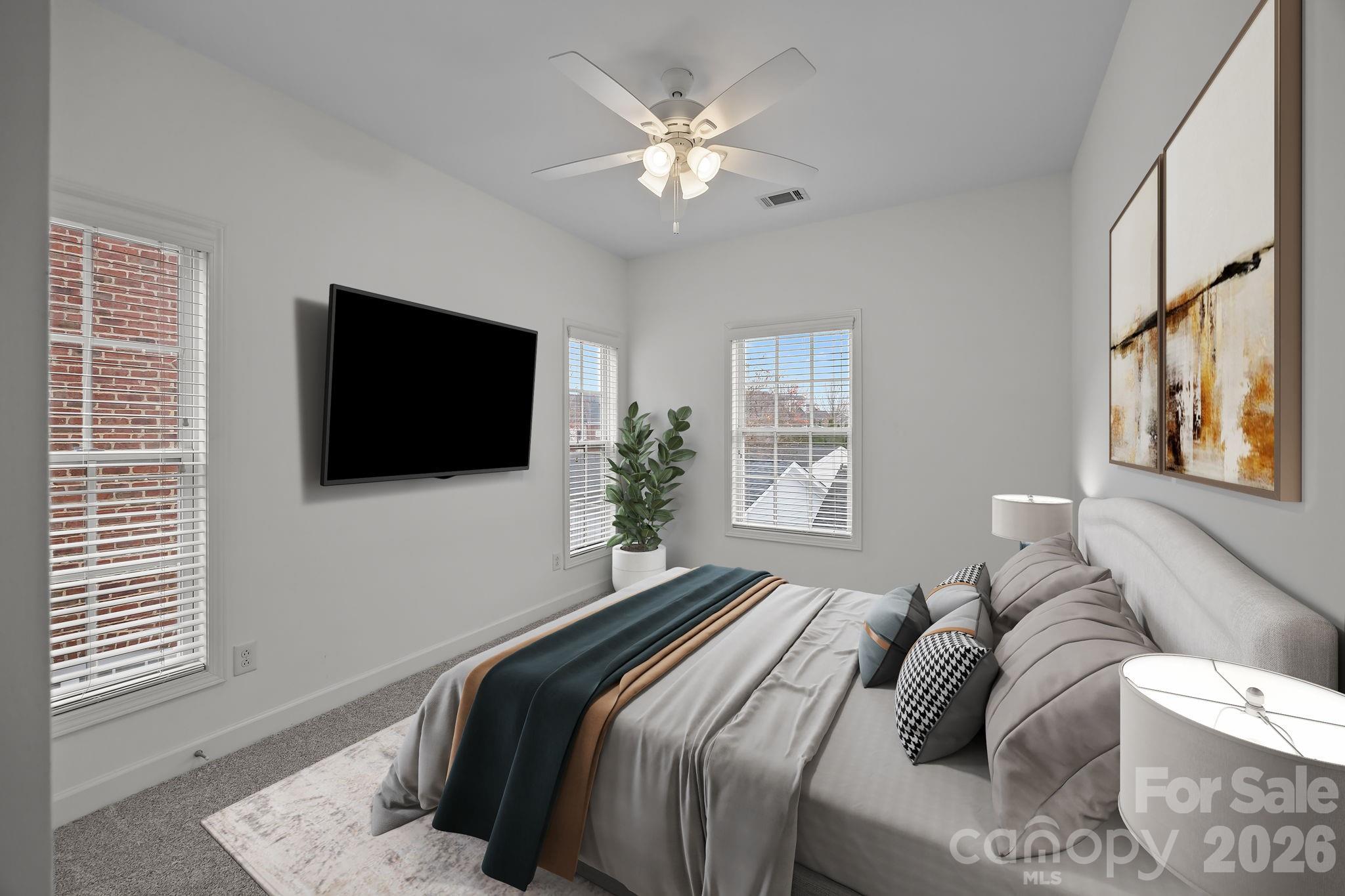 11422 Potters Row Cornelius, NC 28031 - Photo 28 of 46 a bedroom with a large bed and a flat screen tv