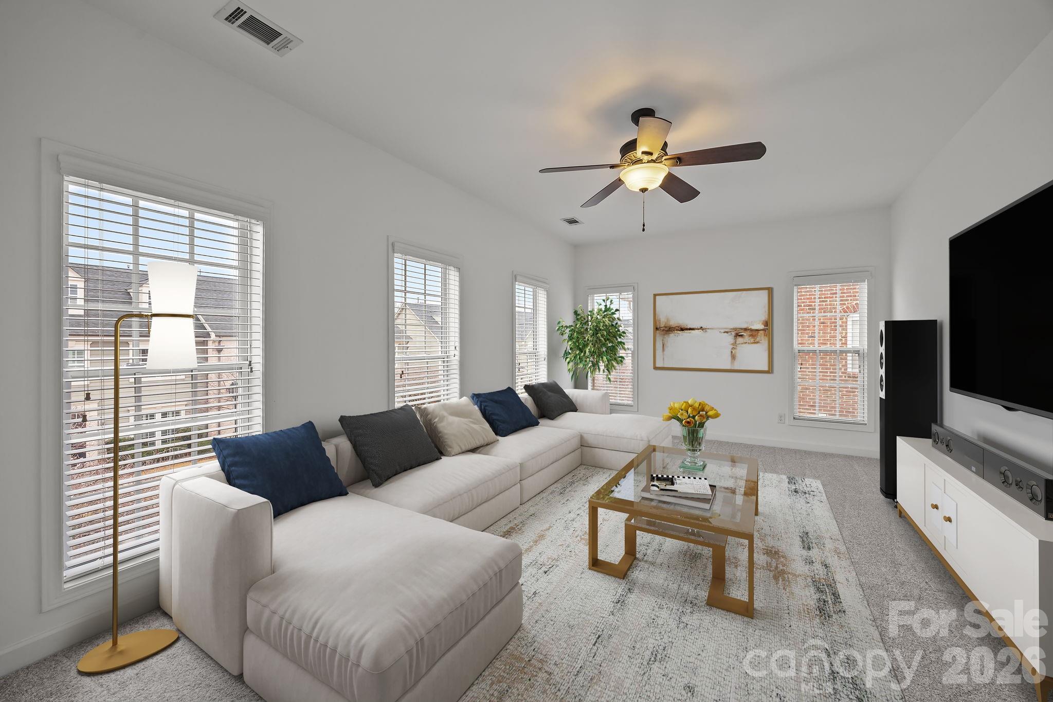 11422 Potters Row Cornelius, NC 28031 - Photo 30 of 46 a living room with furniture and a flat screen tv
