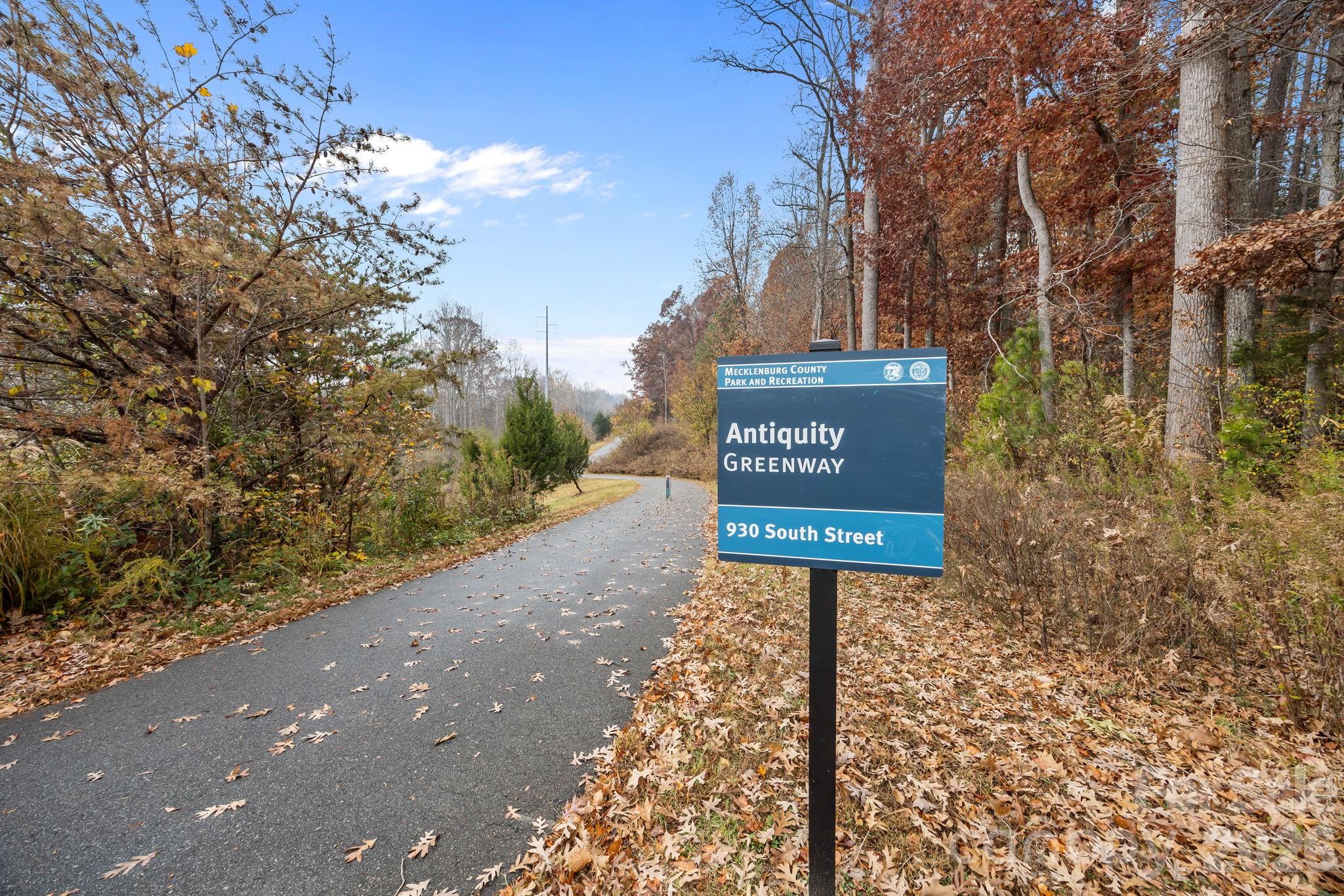 11422 Potters Row Cornelius, NC 28031 - Photo 36 of 46 a sign board with buildings in the background