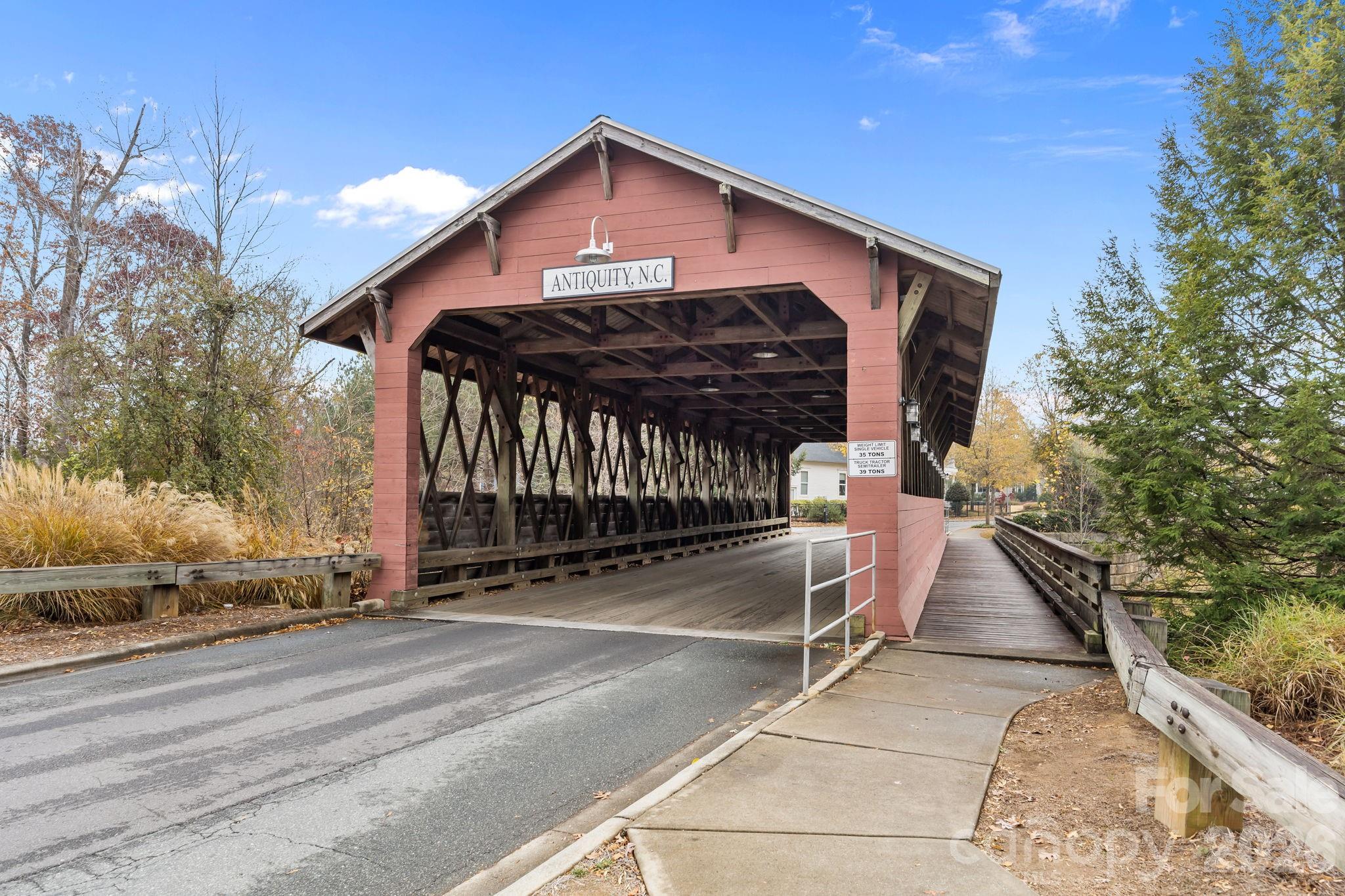 11422 Potters Row Cornelius, NC 28031 - Photo 37 of 46 a front view of a house with basket ball court and wooden fence