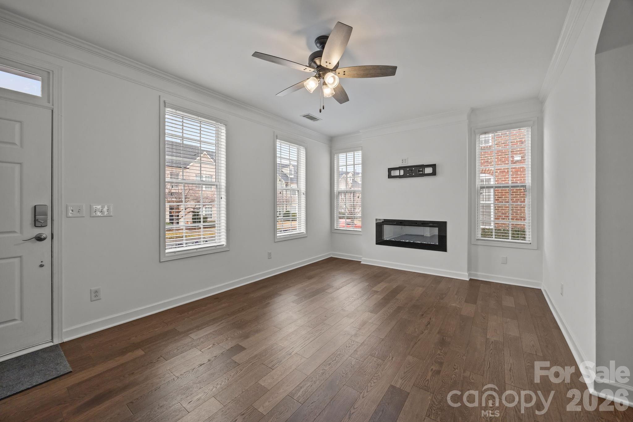11422 Potters Row Cornelius, NC 28031 - Photo 7 of 46 a view of an empty room with a window and wooden floor