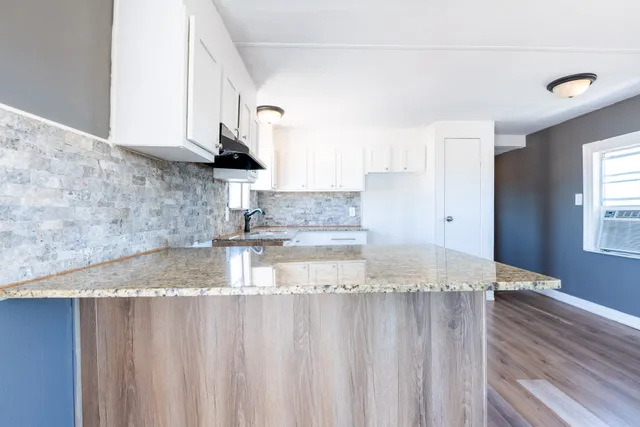 a view of a kitchen with granite countertop a sink