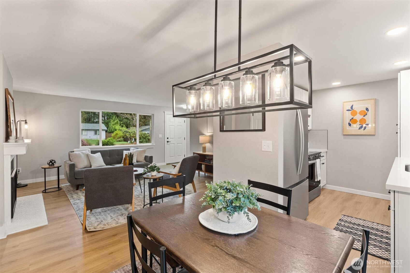 2317 164th Place Southeast Bothell, WA 98012 - Photo 11 of 32 a view of a dining room with furniture a chandelier and wooden floor