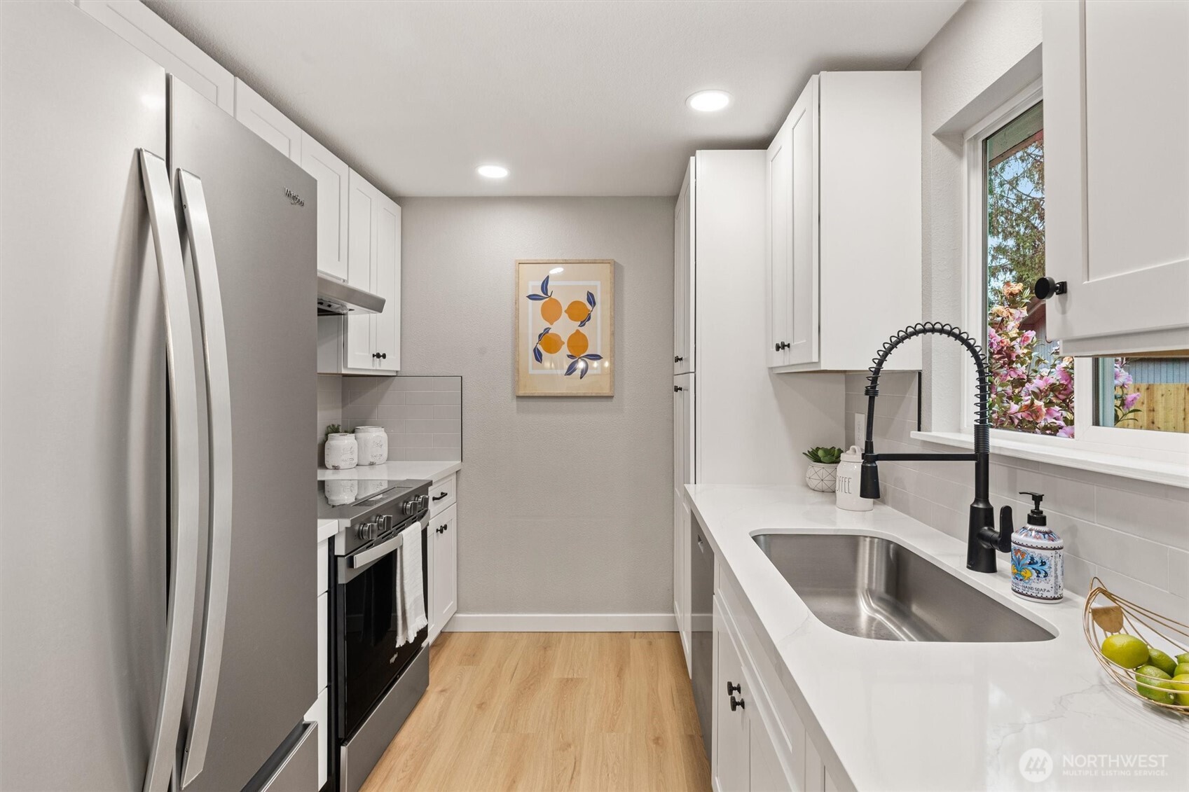2317 164th Place Southeast Bothell, WA 98012 - Photo 12 of 32 a kitchen with stainless steel appliances granite countertop a refrigerator and a sink