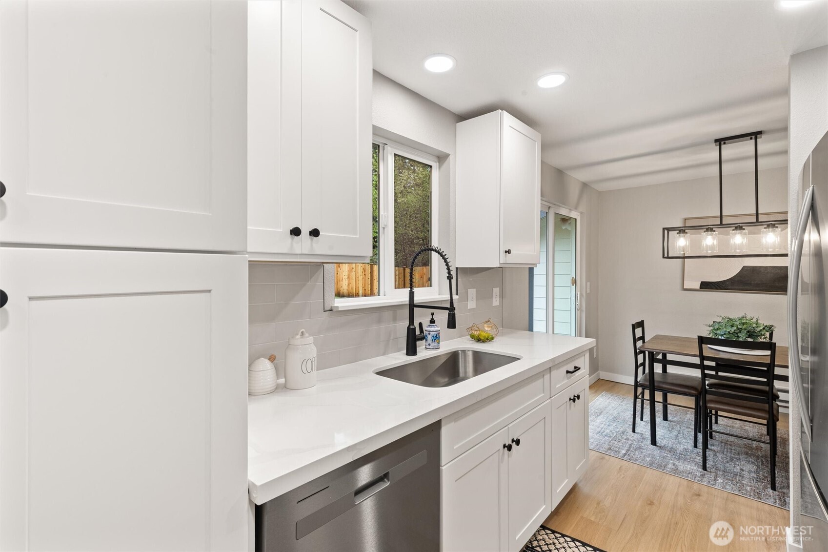 2317 164th Place Southeast Bothell, WA 98012 - Photo 15 of 32 a kitchen with a sink cabinets and wooden floor