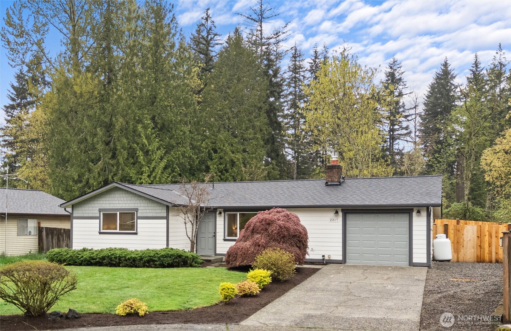 2317 164th Place Southeast Bothell, WA 98012 - Photo 2 of 32 a front view of a house with a yard and garage