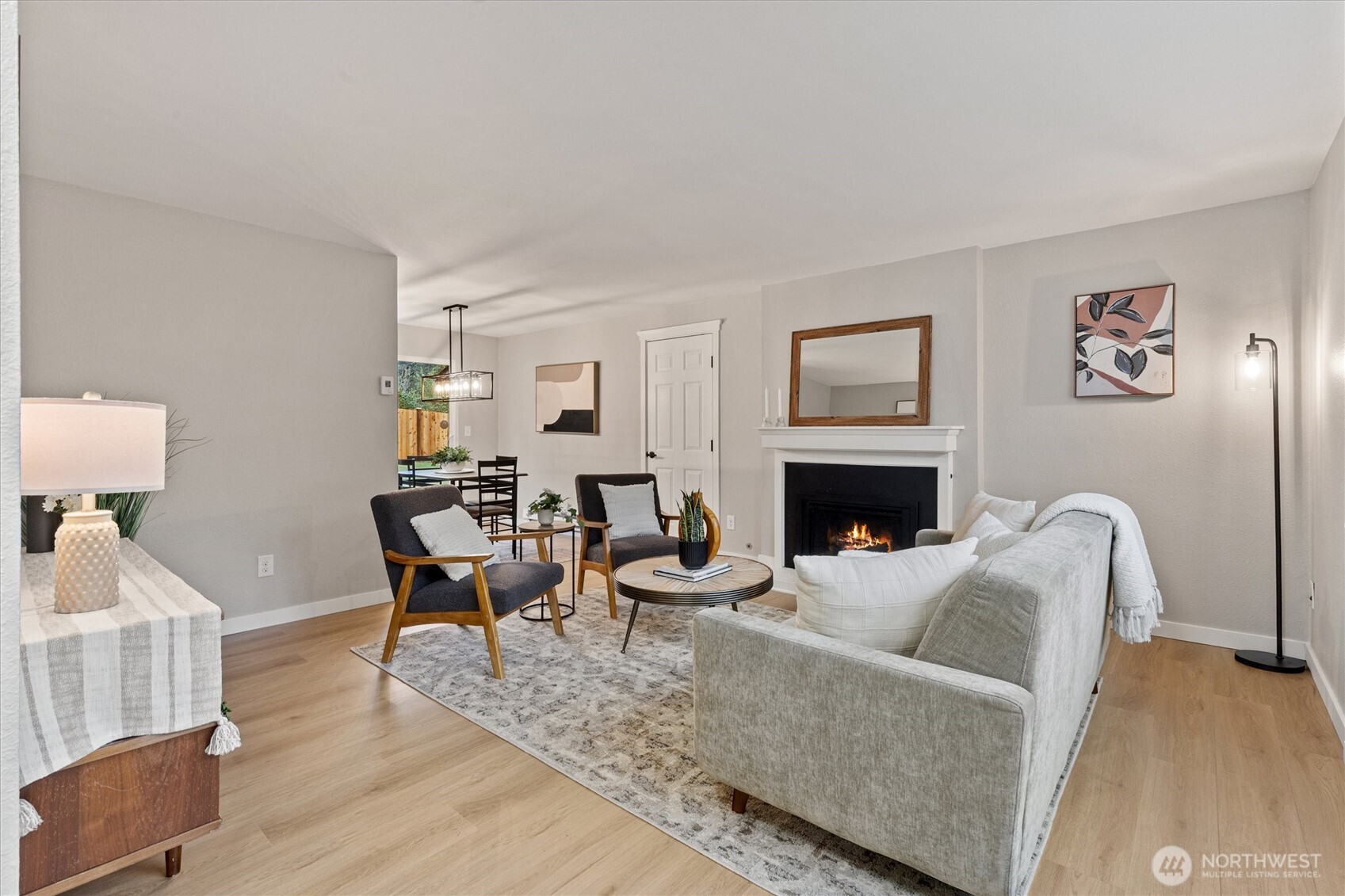 2317 164th Place Southeast Bothell, WA 98012 - Photo 4 of 32 a living room with furniture a large window and a fireplace
