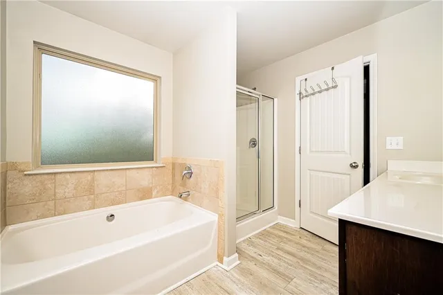 a bathroom with a bathtub and a shower