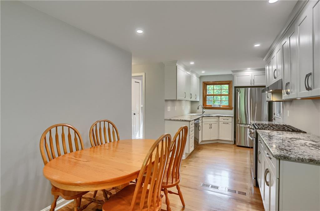 836 Harmony Road Pittsburgh, PA 15237 - Photo 21 of 46 a kitchen with stainless steel appliances kitchen island granite countertop a table chairs sink and cabinets