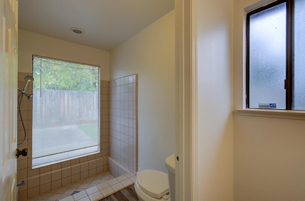 7580 North Angus Street, Unit 103 Fresno, CA 93720 - Photo 22 of 33 a bathroom with a granite countertop sink toilet and shower
