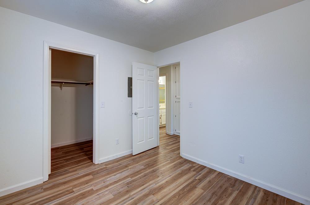 7580 North Angus Street, Unit 103 Fresno, CA 93720 - Photo 24 of 33 a view of an empty room with wooden floor and a window