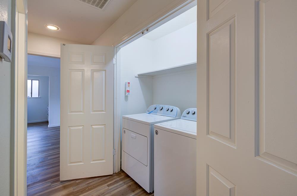 7580 North Angus Street, Unit 103 Fresno, CA 93720 - Photo 26 of 33 a utility room with wooden floor washer and dryer