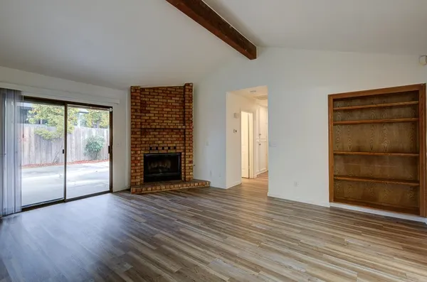 a view of a kitchen with wooden floor and a sink