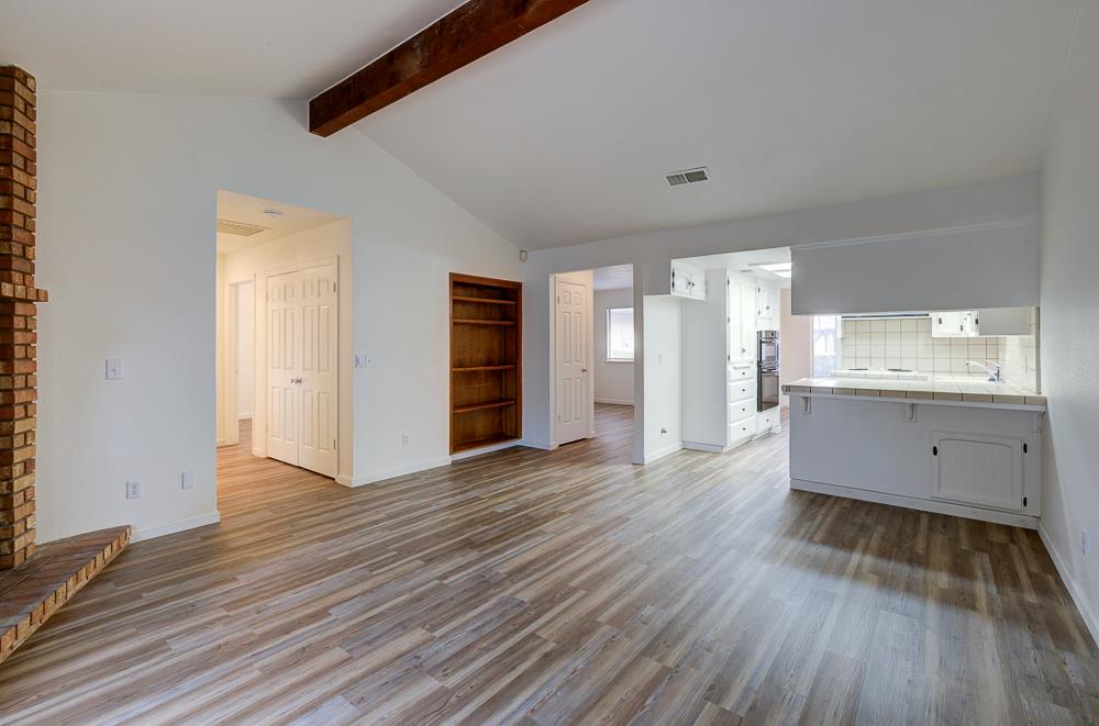 7580 North Angus Street, Unit 103 Fresno, CA 93720 - Photo 10 of 33 a view of a kitchen with wooden floor and a sink