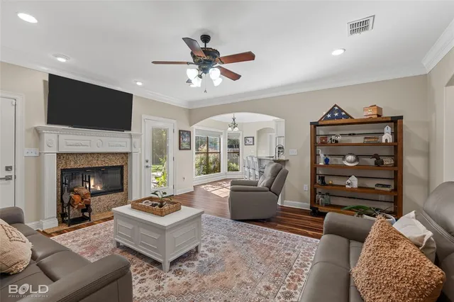 a living room with furniture a flat screen tv and a fireplace