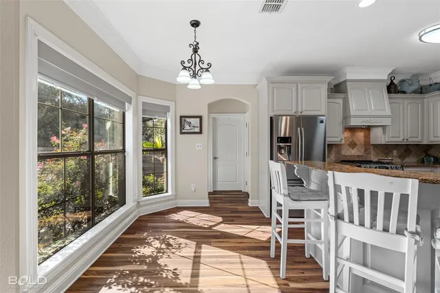 a view of a kitchen with a sink and refrigerator