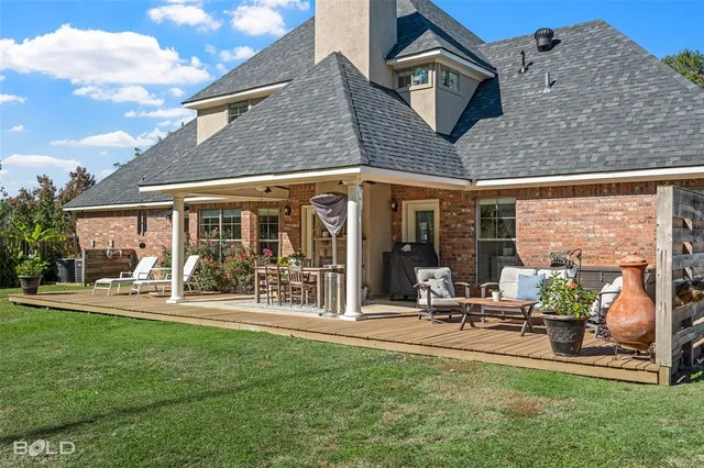 a view of a house with outdoor seating and a garden