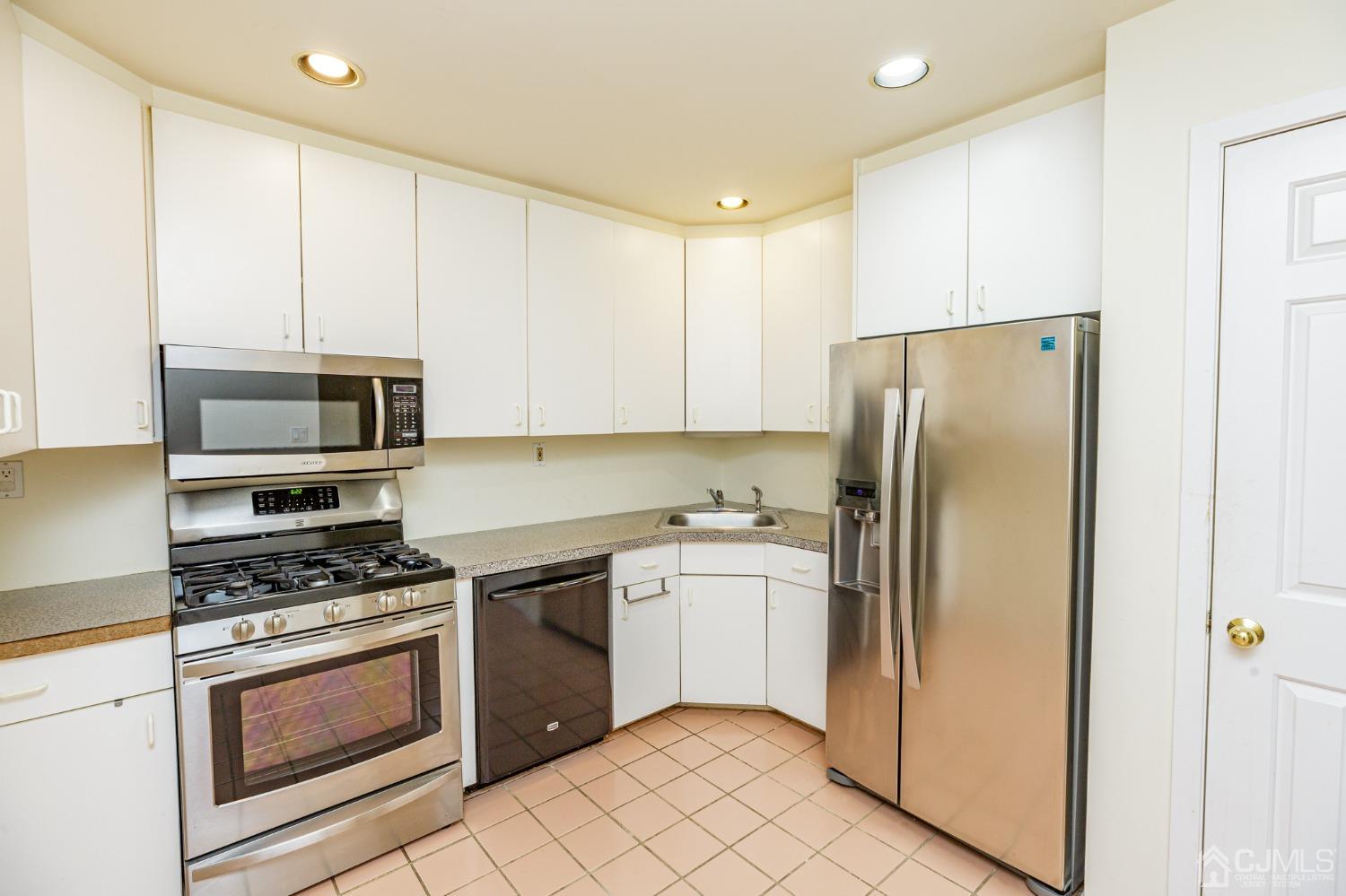 343 Greenfield Road Bridgewater, NJ 08807 - Photo 3 of 31 a kitchen with stainless steel appliances a refrigerator stove and microwave
