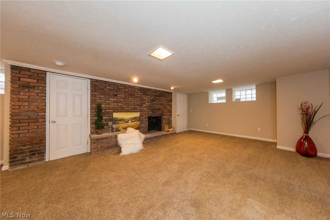 3119 Ludlow Road Cleveland, OH 44120 - Photo 32 of 35 The lower level Recreation Room with exposed brick fireplace