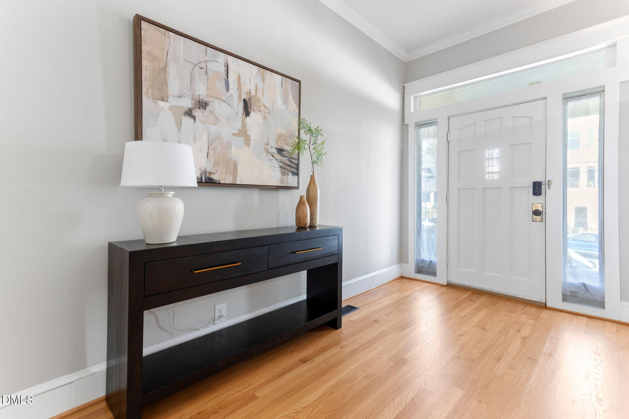 709 West North Street Raleigh, NC 27603 - Photo 11 of 42 a room with painting on the wall and a wooden floor