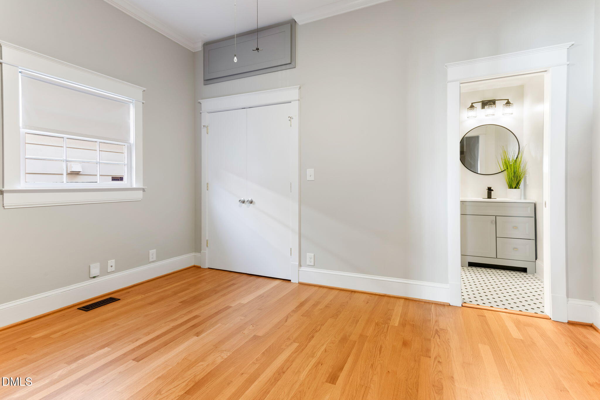709 West North Street Raleigh, NC 27603 - Photo 12 of 42 a view of a room with wooden floor cabinet and a bed