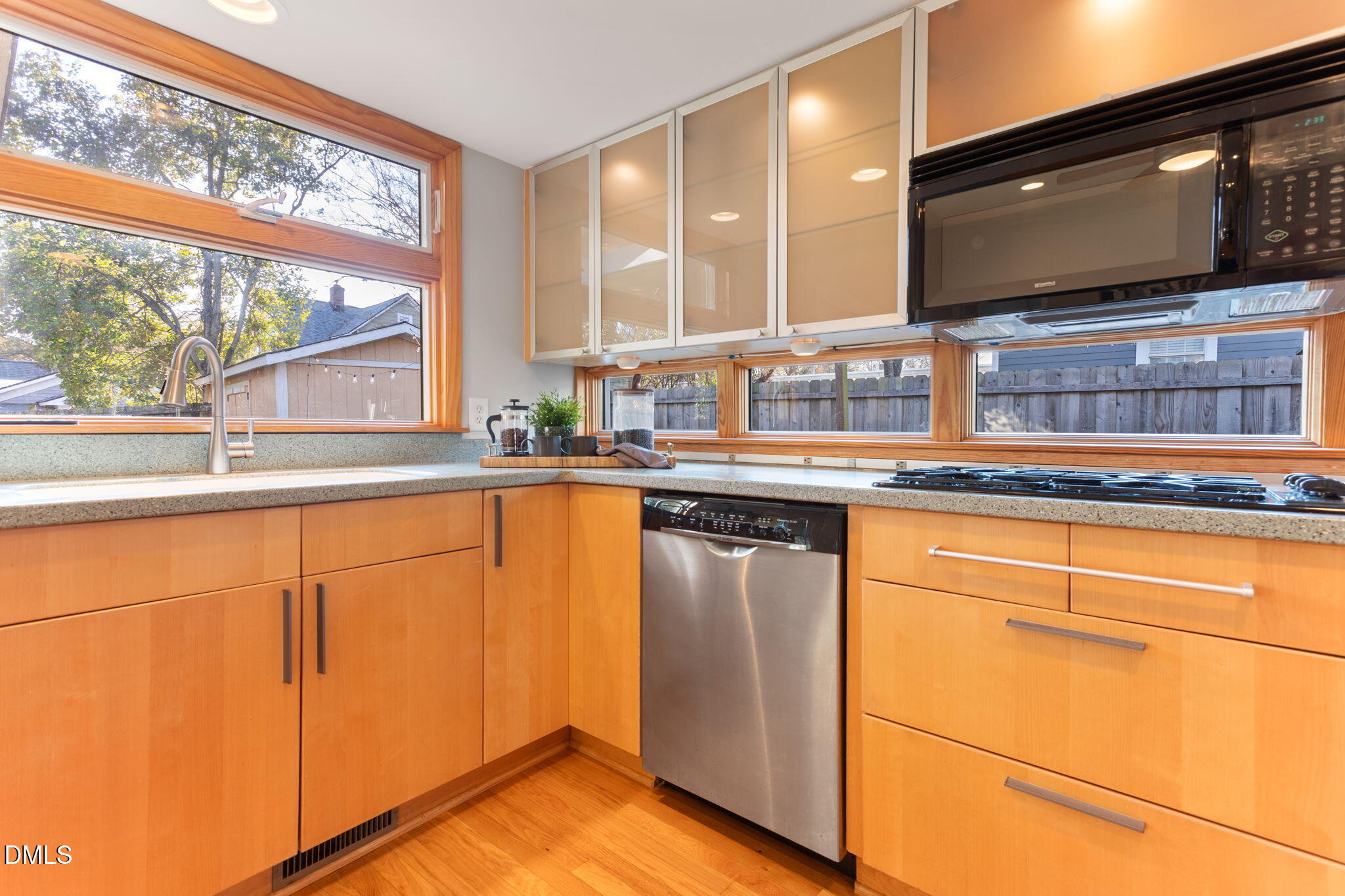 709 West North Street Raleigh, NC 27603 - Photo 7 of 42 a kitchen with stainless steel appliances granite countertop a sink and a microwave