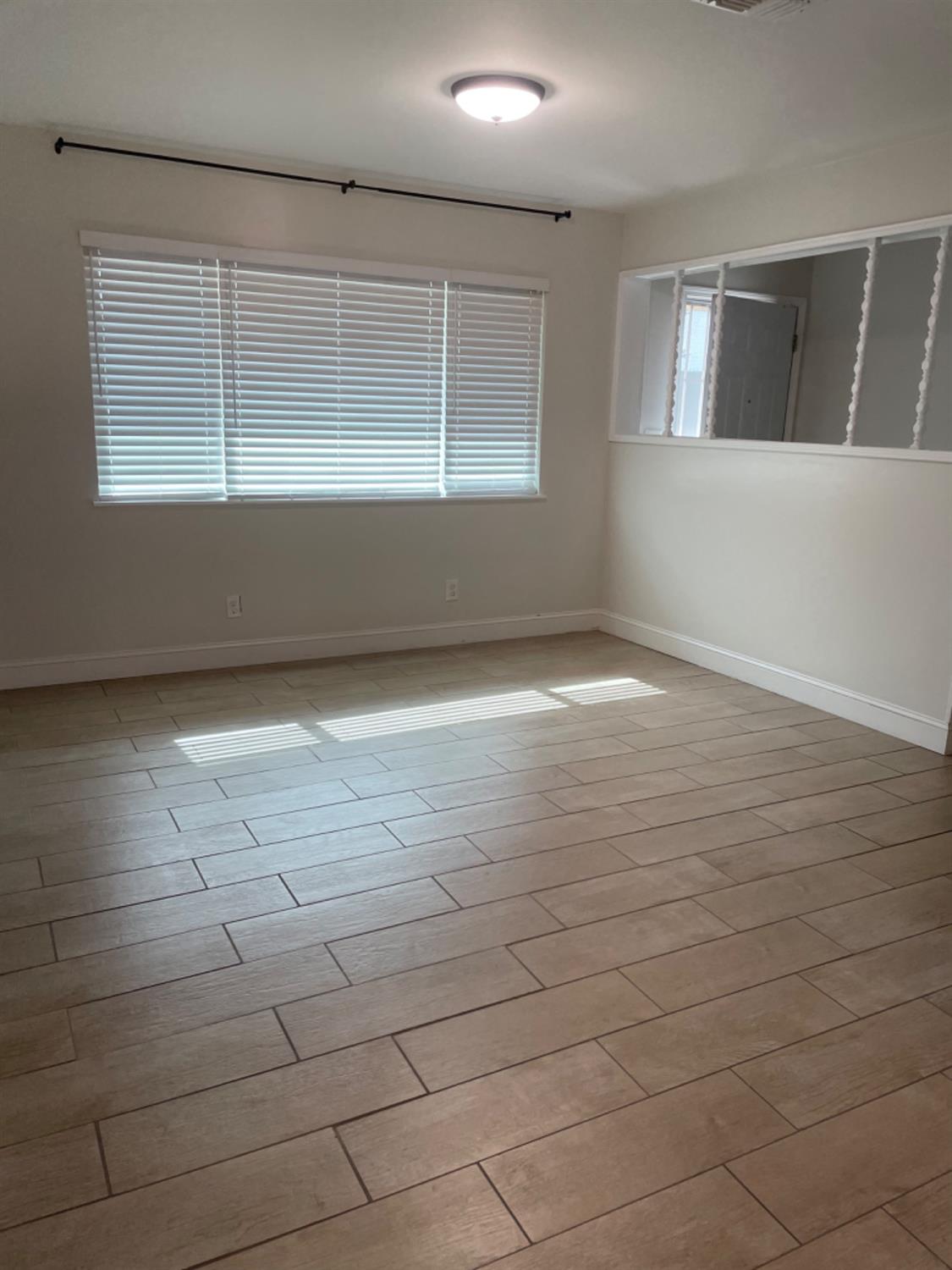 917 Davis Street Madera, CA 93638 - Photo 2 of 10 an empty room with windows