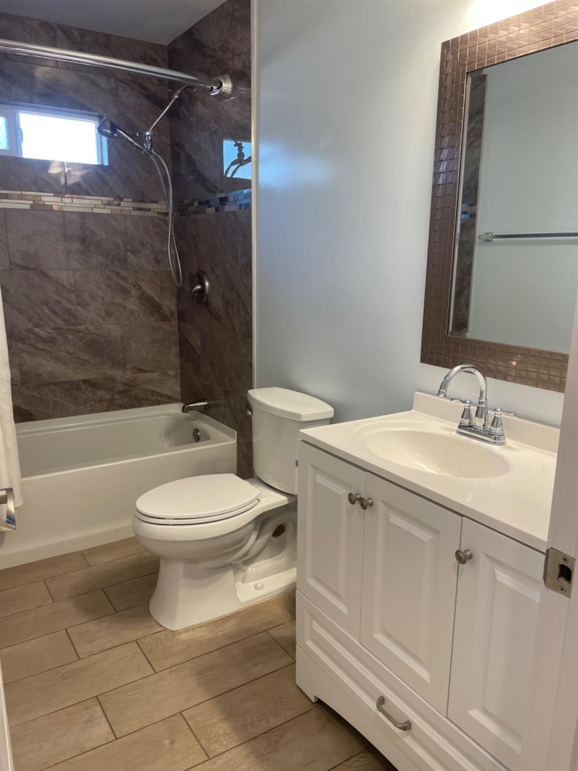 917 Davis Street Madera, CA 93638 - Photo 5 of 10 a bathroom with a sink toilet and shower