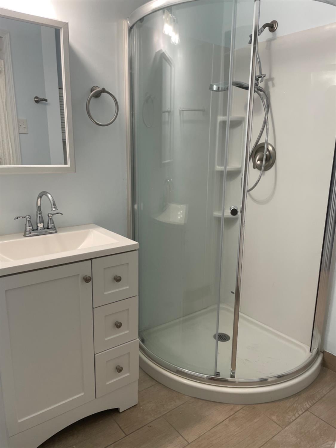 917 Davis Street Madera, CA 93638 - Photo 7 of 10 a bathroom with a shower a mirror and a sink